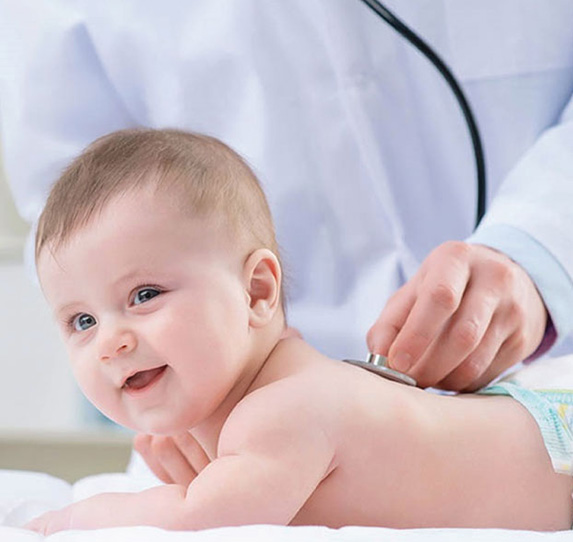 Smiling pediatric doctor with a child